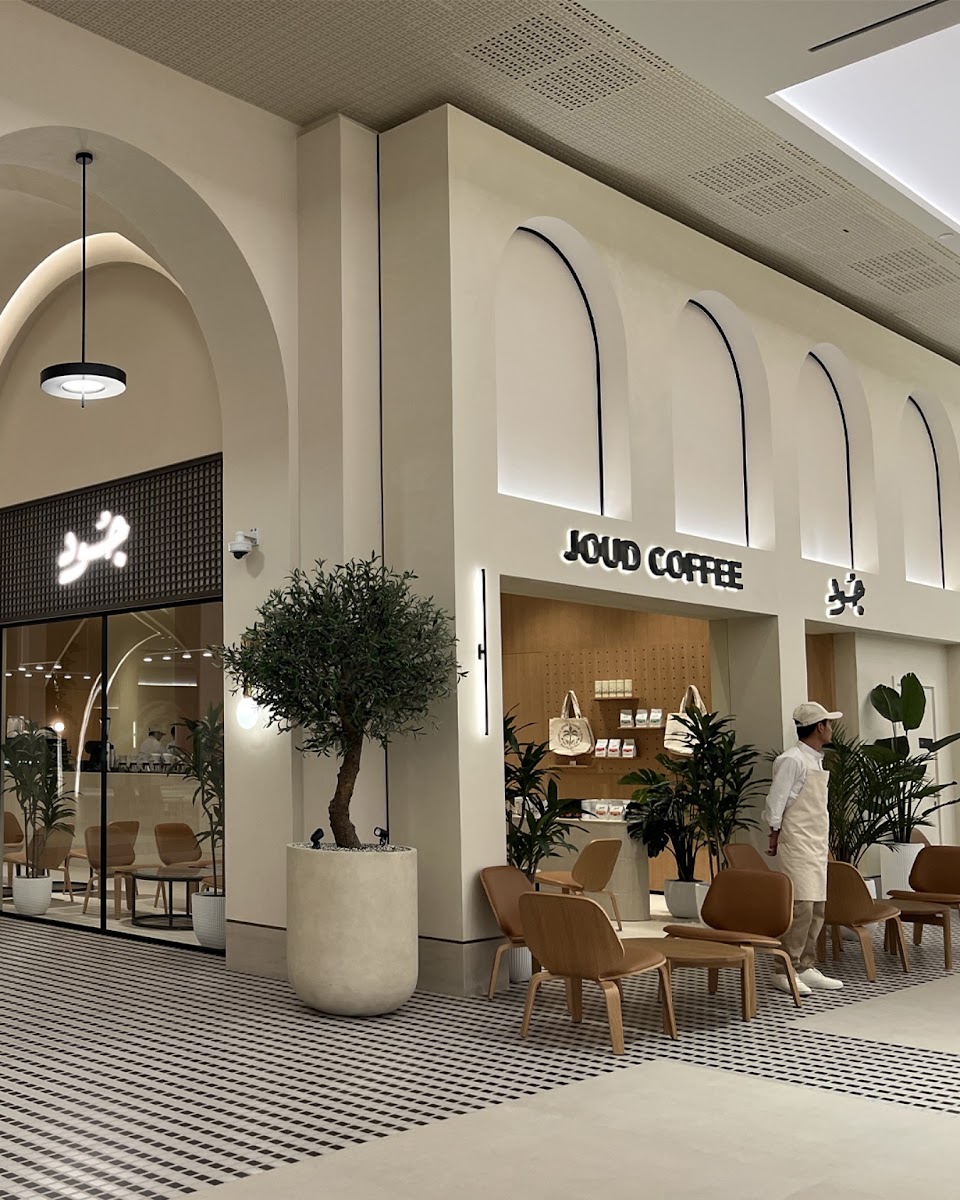 Illuminated Letters on Minimalist Arched Facade - Metroplus detail view