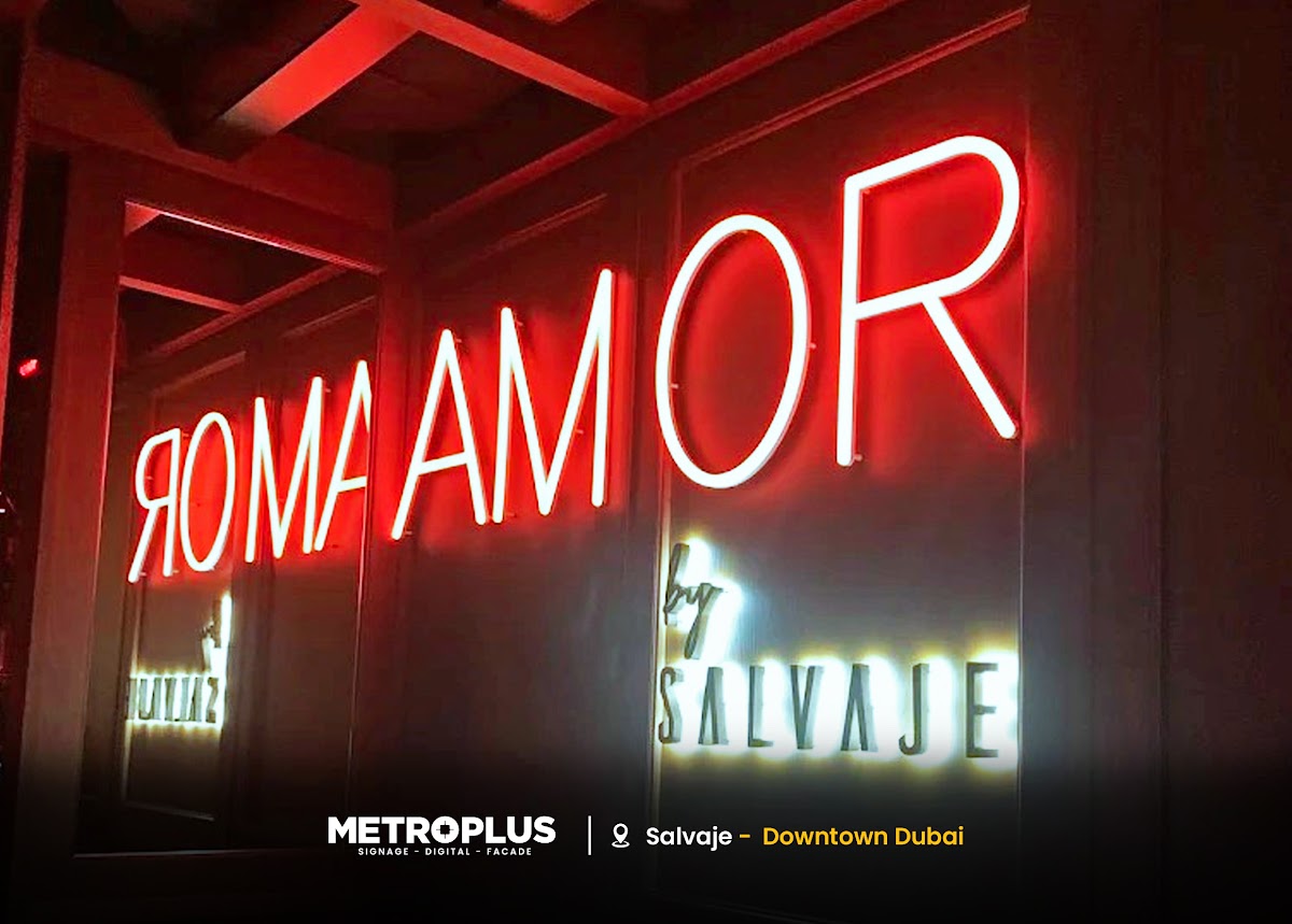 Illuminated Script Signage Above a Sculptural Entrance - Metroplus detail view
