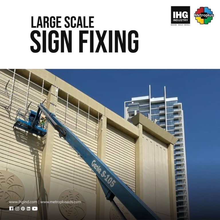 Metroplus installation team fixing large-scale signage at height