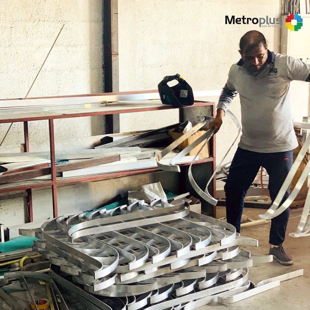 Metroplus in-house team fabricating signage in the workshop