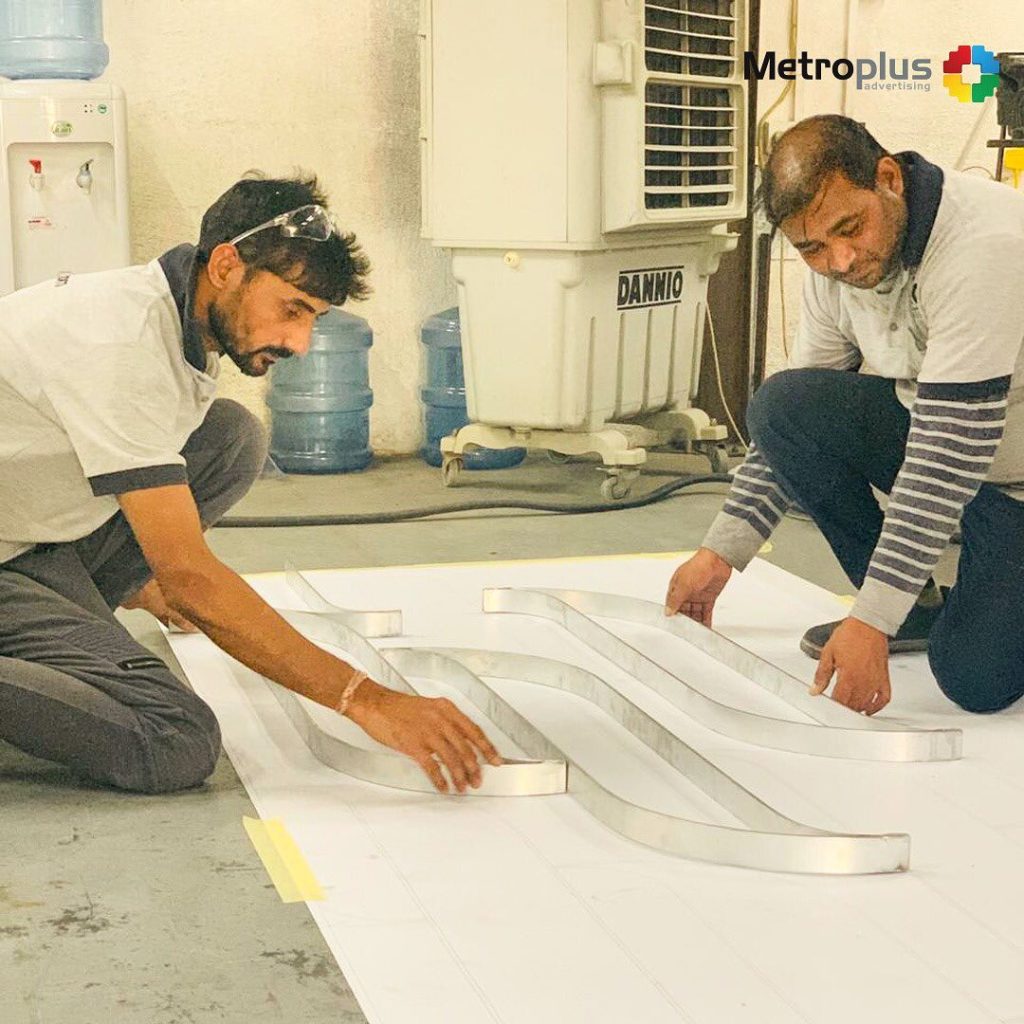 Metroplus in-house team fabricating signage in the workshop