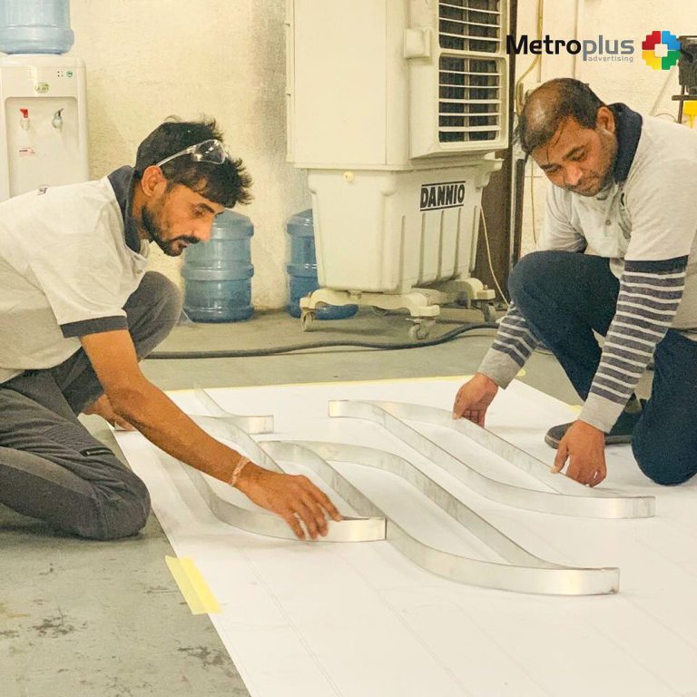 Metroplus in-house team fabricating signage in the workshop
